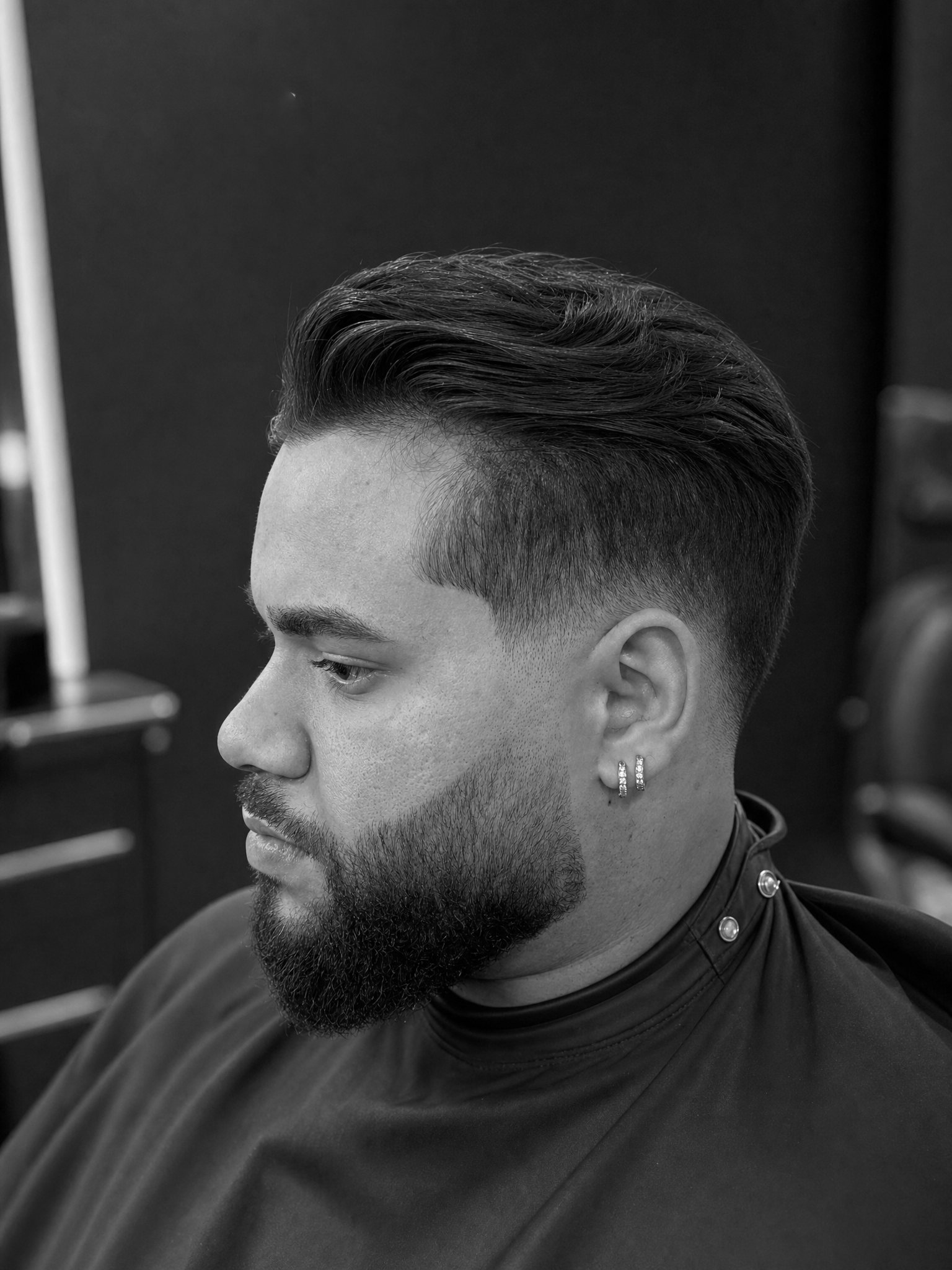 Precision fade haircut paired with a shaped beard